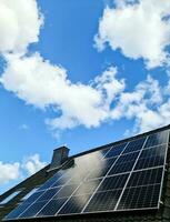 Solar panels producing clean energy on a roof of a residential house photo