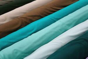 Detailed close up view on samples of cloth and fabrics in different colors found at a fabrics market photo