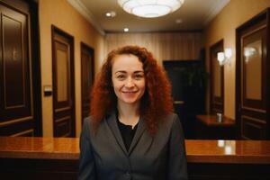 A friendly woman at the reception of a hotel created with technology. photo