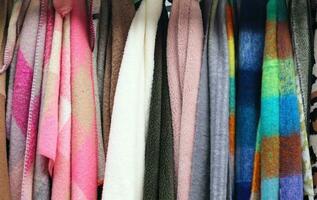 Detailed close up view on samples of cloth and fabrics in different colors found at a fabrics market photo