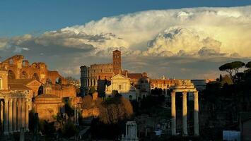 Ancient Rome at sunset, with a huge cloud in the sky photo