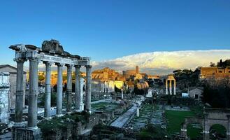 The Roman Forum, in Rome, with a huge cloud in the sky photo