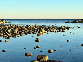 Rocks in the middle of the calm sea photo