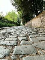 Via Appia Antica in Rome in Italy. A archeological Roman road photo