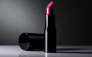 Pink lipstick in dark moody studio shot. Product and make up photo concept. .