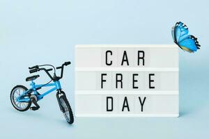 Car free day concept. Light box with Car free day text bicycle and butterfly. World bicycle day photo