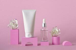 Beauty natural skincare product mock up. Cream tube, serum bottle and flowers on different geometric podiums. Skincare products presentation photo