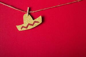 Sombrero hat made of shiny paper on red background. Minimal festive decoration. Cinco de mayo concept photo