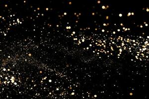 Black festive background. Abstract scattering of gold sparkles on black. Holiday backdrop, selective focus photo