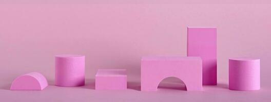 Abstract pink banner with different shape podiums for products presentation or exhibitions. Geometric composition with copy space photo