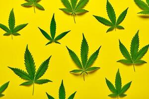 Abstract yellow background with hemp leaves pattern photo