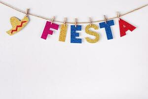 DIY paper Garland made of Fiesta word and sombrero. Fragment of festive decoration of interior. Cinco de mayo celebration photo