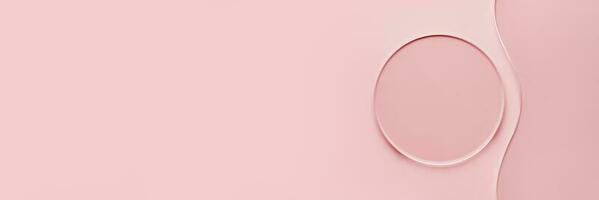 Empty round petri dish and wavy glass slide on pink banner. Mockup for cosmetic or scientific product sample photo