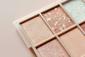 Eyeshadow colorful shades palette in beige tones close-up. Beauty abstract background photo