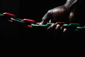 Uneteenth National Independence Day celebration concept. A hand squeezes a red green chain. illustration photo