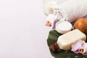 Coconut oil and tropical leaves. Hair care spa concept photo