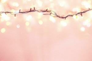 Yellow garland on a pink background. Holiday Christmas concept photo