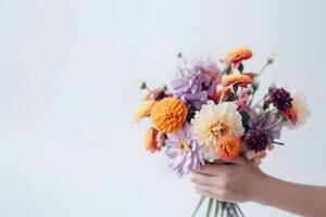 Female hand holds beautiful bouquet of dahlias and chrysanthemums. Mothers day, holiday decor, Flower delivery concept. illustration photo