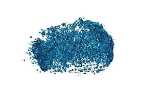 Blue glitter makeup product smear on white. Eye shadow, lip gloss and face for holiday makeup swatch photo