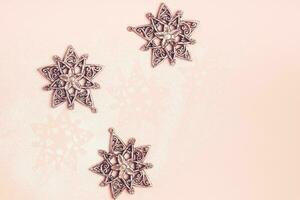 Vintage silver Christmas toys snowflakes on pink background photo