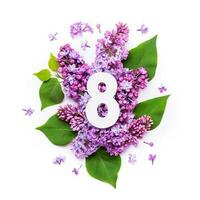 Paper number eight on background of lilac flowers. Minimal creative Layout with natural elements for your design photo