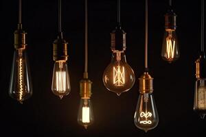 Set of vintage glowing light bulbs on dark background. photo