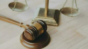 Justice and law concept.Male judge in a courtroom with the gavel, working with, computer and docking keyboard, eyeglasses, on table in morning light video