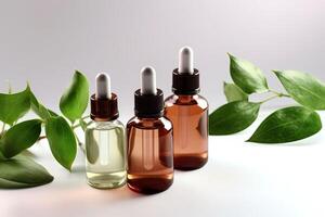 Cosmetic serum in a glass bottles with green leaves on light background. photo