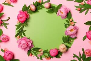 Floral round frame, wreath made of a lot of peonies flower buds and green leaves. photo