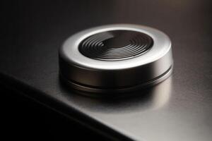 Modern black round shaped button with brightsign. Hardware equipment concept. photo