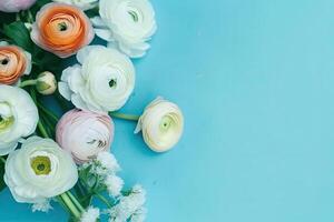 Spring ranunculus flowers bouquet on blue pastel background top view in flat lay style. photo
