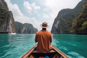 Tourist man in hat relaxing on boat at the beautiful islands, back view. photo