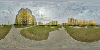 360 hdri panorama view with skyscrapers in new modern residential complex with high-rise buildings in townwith overcast sky in equirectangular spherical projection, ready AR VR virtual reality content photo