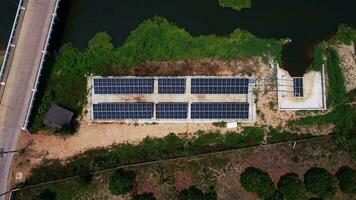 Top view on photovoltaic solar power panels. Drone aerial view of solar panels with water pumps, agricultural equipment for irrigation near rivers from clean energy or solar energy. video