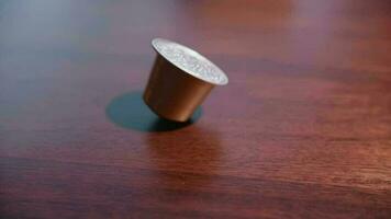 A brown coffee pod falling in slow motion video