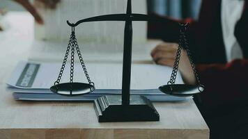 Justice and law concept.Male judge in a courtroom with the gavel, working with, computer and docking keyboard, eyeglasses, on table in morning light video