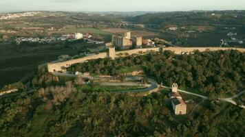 Panoramic View Of Medieval Town And Castle Surrounded By Lush Green Foliage In Obidos, Portugal. - Aerial Drone Shot video