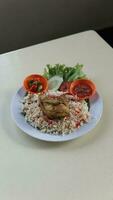 Rice with chicken and vegetables on the table in a restaurant photo