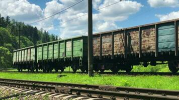 Old freight train rides on railways. Close up video