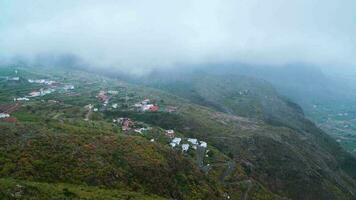 Aerial timelapse to the surface of the island of Tenerife - mountain village, road, low clouds. Canary Islands, Spain video