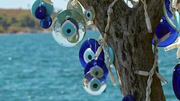 Traditional Turkish Blue Evil Eye Wishing Stones Hanging on a Tree video