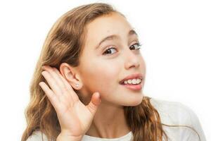 Young girl making a listening gesture isolated on white background photo