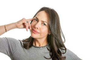 Closeup portrait of a beautiful young woman thinking or having an idea isolated on white background. photo