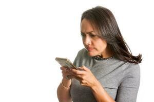 Angry woman texting on her cellphone isolated on white background photo