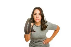 Angry young mother with belt on her hands photo