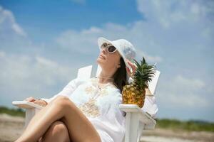 Woman relaxing at a paradisiac tropical beach in a beautiful sunny day photo