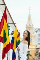 Beautiful woman walking around Cartagena de Indias next to the famous Clock Tower photo