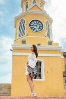 Beautiful woman walking around Cartagena de Indias next to the famous Clock Tower photo