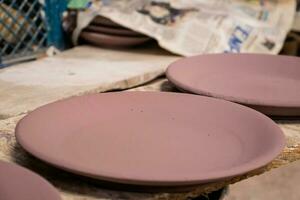 Ceramics on the elaboration process at a traditional factory at the small city of Raquira in Colombia photo