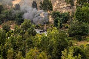 Chimney of a traditional factory during ceramics firing at the small city of Raquira. The city of pots, Colombia photo